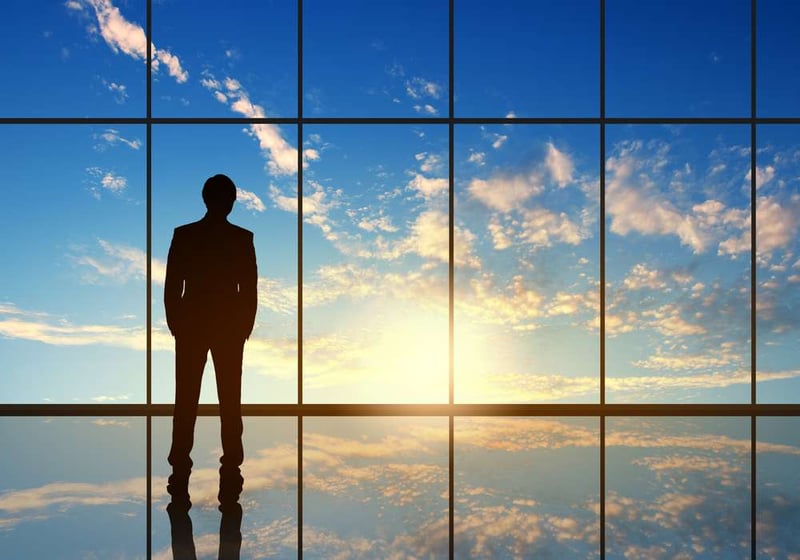 Silhouette of businessman against panoramic office window